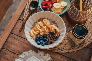 Oatmeal topped with fruit Chocolate and bee pollen