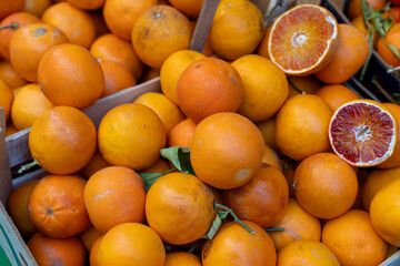 A crate full of oranges and a half orange