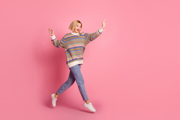 Fototapeta na wymiar Full size photo of ecstatic satsifed woman wear ornament pullover jumping looking at her new shoes isolated on pink color background