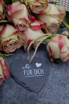 background with antique roses on concrete background with text and sign: " for you"