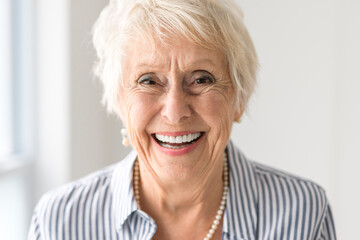 senior lady posing at home portrait close to a window