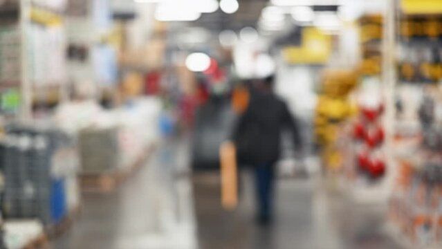 Blurred hardware store inside, people and punishment. Defocus, slow motion