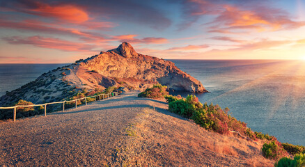 Picturesque summer view of Kapchik cape with walk path to the top. Colorful sunrise in Crimea,...
