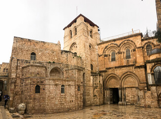 Fototapeta na wymiar Entrance to the Church of the Holy Sepulcher (Latin: Ecclesia Sancti Sepulchri) on a rainy day