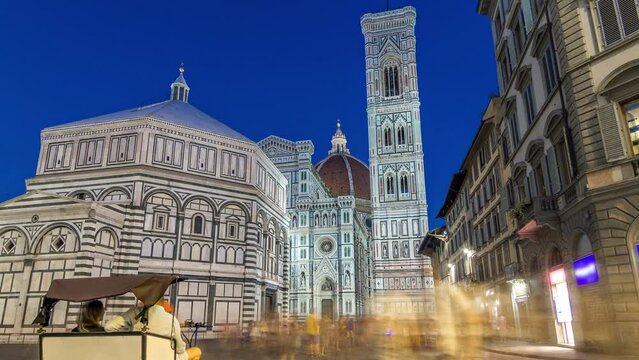 Basilica di Santa Maria del Fiore and Baptistery San Giovanni day to night transition timelapse. Cathedral church (Duomo) of Florence in Italy. Evening illumination. Bell tower and dome after sunset