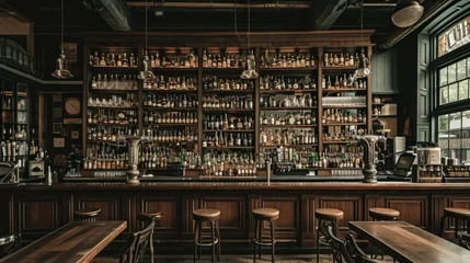 Fotobehang Wide variety of bottles of alcohol or liqueur are placed on the shelves of a vintage bar © Ruslan Gilmanshin