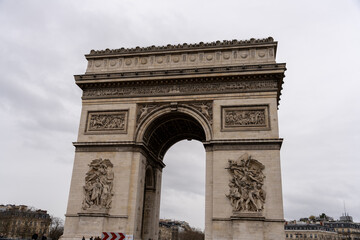 Fototapeta na wymiar The Arc de Triomphe is a large, white arch with intricate carvings