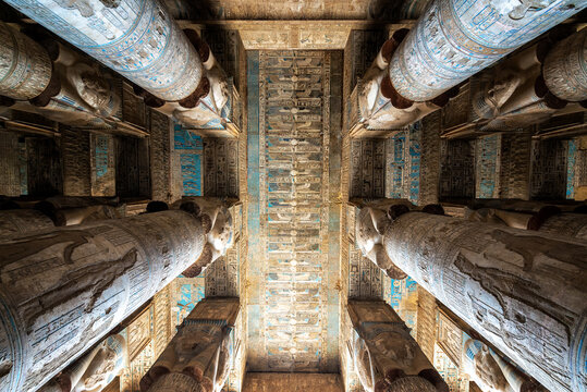 Looking up at the ornately decorated columns and ceiling of the Temple of Hathor in Dendera, Egypt