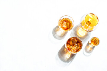 Strong alcohol drink. Cognac, whisky, rum, tequila at white background. Flat lay with copy space.