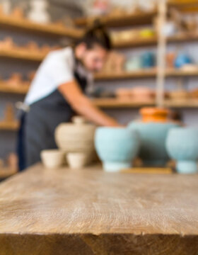 Empty table in ceramic workshop and local interior, pottery and small ceramic arts workshop, crafts or creative startup studio. Empty workstation of an art room for craft, painting or clay molding cla