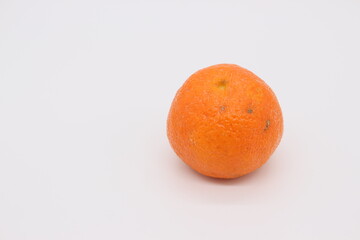 A very appetizing orange tangerine is depicted on a light background.