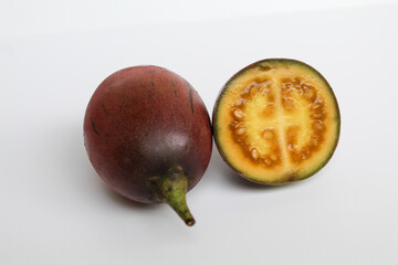 Sliced Tamarillo or Solanum betaceum fruit. Isolated on white background