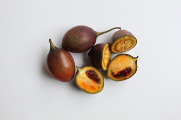 Sliced Tamarillo or Solanum betaceum fruit. Isolated on white background, flat lay or top view