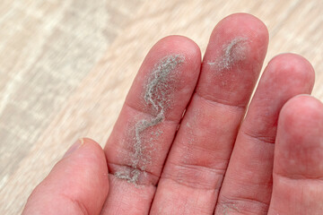 Close-up of palm with dust on fingers - 753050110