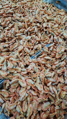 Frozen boiled shrimp in a supermarket or grocery store, close-up. Seafood