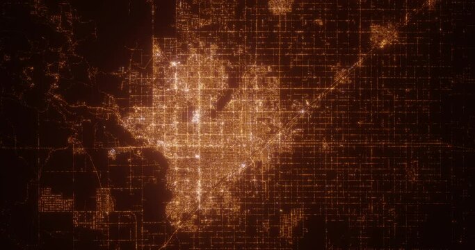 Fresno (California, USA) top view at night. Aerial view on modern city from space. Camera is flying above the city, moving forward. Vertical video. The north is on the left side
