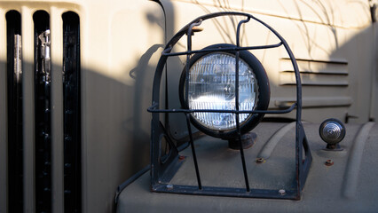 Headlights of an old military car close-up, details of design equipment