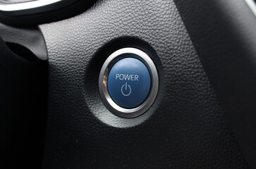 Start Stop Engine button with blue letters. New hybrid Car engine start button. Modern hybrid car interior, key button.