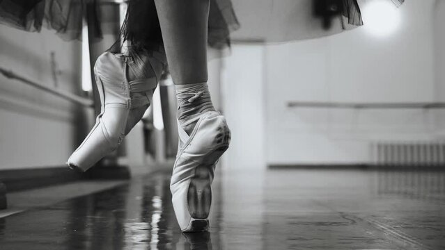 Ballerina training in pointe shoes in the ballroom
