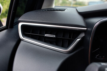 Car air vents close-up grille. Air ventilation grille with power regulator. Modern Car air...