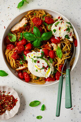 Chicken spaghetti with burrata cheese ,cherry tomatoes and lemon butter  garlic sauce.top veiw .