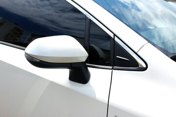 Rear-view mirror. Rear view mirror modern white car. Wing mirror of a modern car. White side mirror car. Back view. Rear-view mirror moder car.  - obrazy, fototapety, plakaty