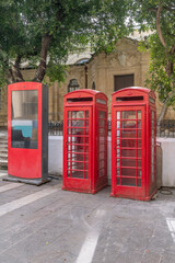 A pair of old red telephone booths in the historic center of Valletta, Malta