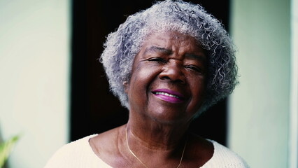 Portrait of a senior African American woman with gray hair looking at camera. One elderly black...
