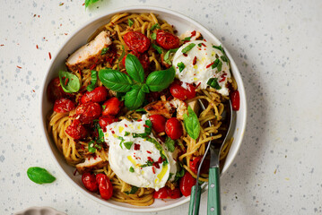 Chicken spaghetti with burrata cheese ,cherry tomatoes and lemon butter  garlic sauce.top veiw .