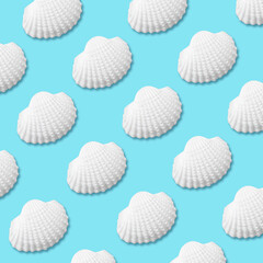 Creative seashell pattern on bright blue background. Summer minimal concept.