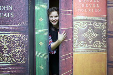  Happy blogger looking out of the door in the form of large books in the quest Funlock for bloggers