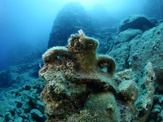 Fototapeta na wymiar scuba diver underwater exploring ancient amphoras deep water history search ocean scenery