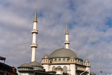 A large white and grey building with two tall towers