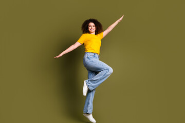 Full body photo of young woman chevelure hair jumping flying like wings arms feel freedom in relations isolated on khaki color background