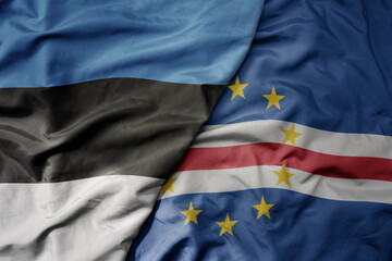 big waving national colorful flag of cape verde and national flag of estonia.