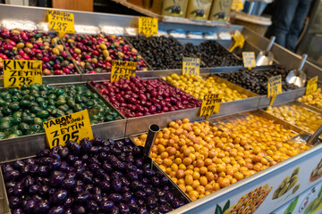 A display of various colored olives for sale