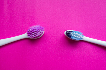 Used toothbrush isolated on pink background. Old toothbrush. Top view, copy space.