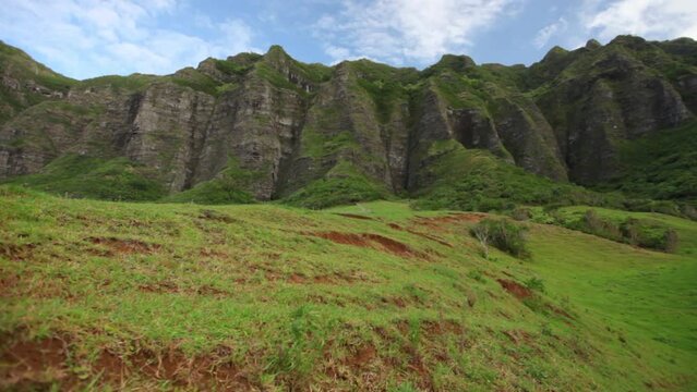 Epic steady cam shot on grassy hill in Hawaiian valley - Cinematic