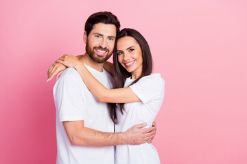 Photo portrait of lovely young couple hugging love each other dressed stylish white garment isolated on pink color background