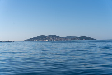 Fototapeta na wymiar A calm blue ocean with a small island in the distance