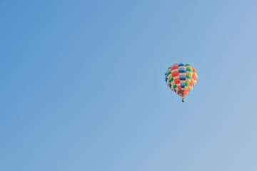 Hot air balloons landing in a mountain flight over field and forest,colorful Hot air balloons flying over the valley with blue sky,Tourism concept.