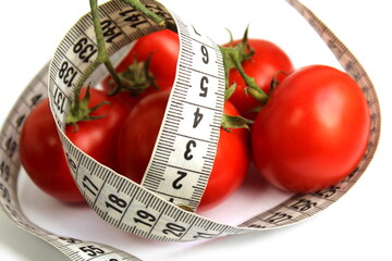 Red ripe tomatoes are wrapped with a centimeter soft ribbon.	