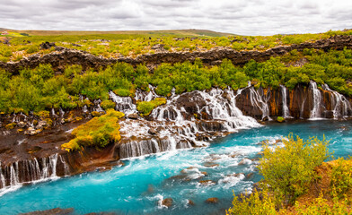 Panoramic view of Hraunfossar near Borgarfjörður (Iceland), a series of waterfalls and cascades...