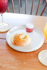 Bagel with cream cheese and strawberry jam on a plate in luxury restaurant,copy space.