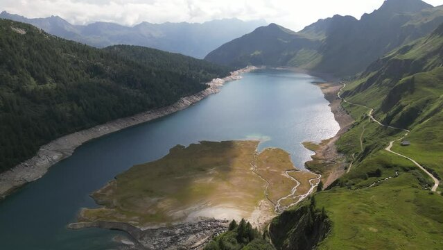 Drone view of the scenery landscape of Lake Ritom in Switzerland with cloudy sky