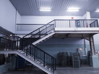 Interior of the stairs leading to the top floor in an industrial office building.