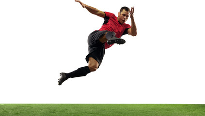Young man, soccer player in black and red uniform, hitting ball in a jump, playing isolated on...