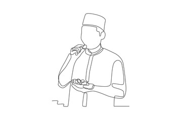 A man is eating dates