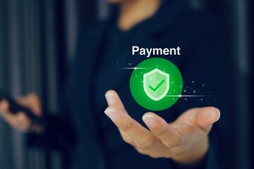 Businessman holds payment icon using NFC payment, cashless technology, contactless and money transfer concept.