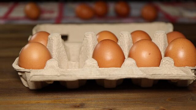 hand picks eggs from biodegradable cardboard box